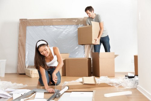 Man and van loading boxes into a moving vehicle