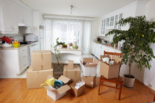 Local movers transporting a piano through a residential area in Twickenham