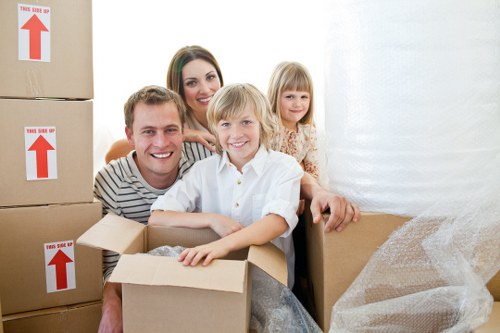 Professional movers handling furniture and packed boxes
